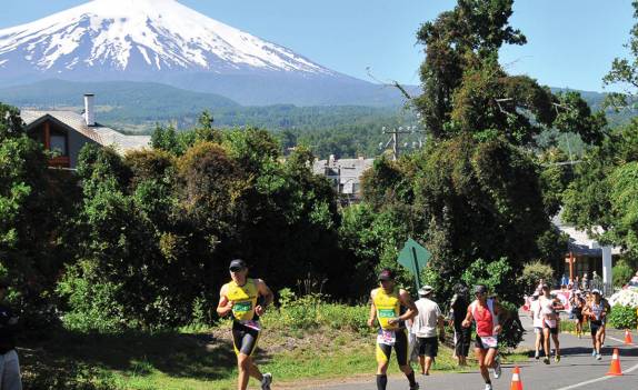 Atletas fazem a parte da corrida no tradicional triatlo de Pucón, no sul do Chile. Ao fundo, o vulcão Villarrica. Essa é considerada uma das mais belas provas de triatlo do mundo (foto da internet)